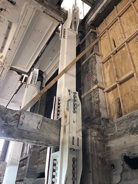 Bespoke stiffened splice plates allow new steel columns to bypass the existing floor beams