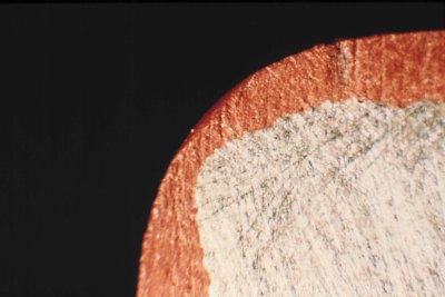 Cross-section showing reduction in coating thickness at a corner
