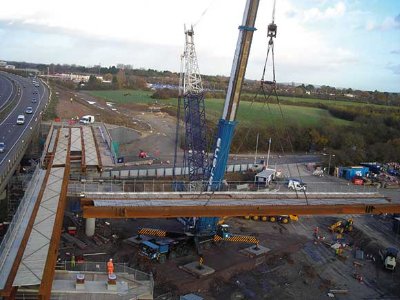 The initial temporary bridge is being built adjacent to the existing viaduct