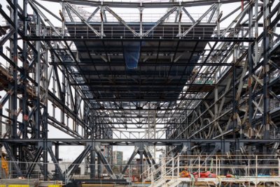 Numerous trusses are needed to form the open-plan entertainment spaces as well as helping the building to span over an existing road