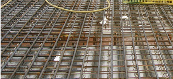 Transverse bottom mat reinforcement between studs and permanent formwork