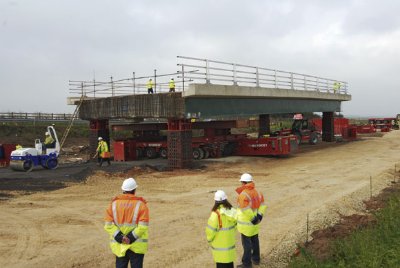 Multi-axle SPMTs lifted, carried and jacked the completed steel bridge into position