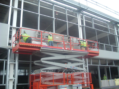 Scissor lift used to safely erect wall cladding