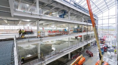 The factory features a full-height glazed atrium
