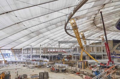 Construction progresses within the vast dome