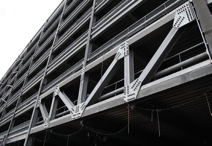 Large trusses form the access and exit points on the ground floor