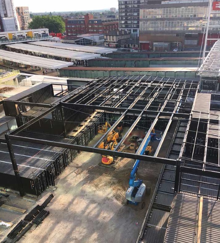 An independent roof structure covers the containers