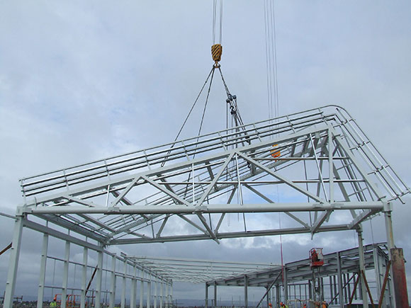 A feature wind catcher is craned into position