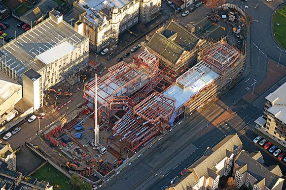 The steel structure wraps around a retained building once used as a granary