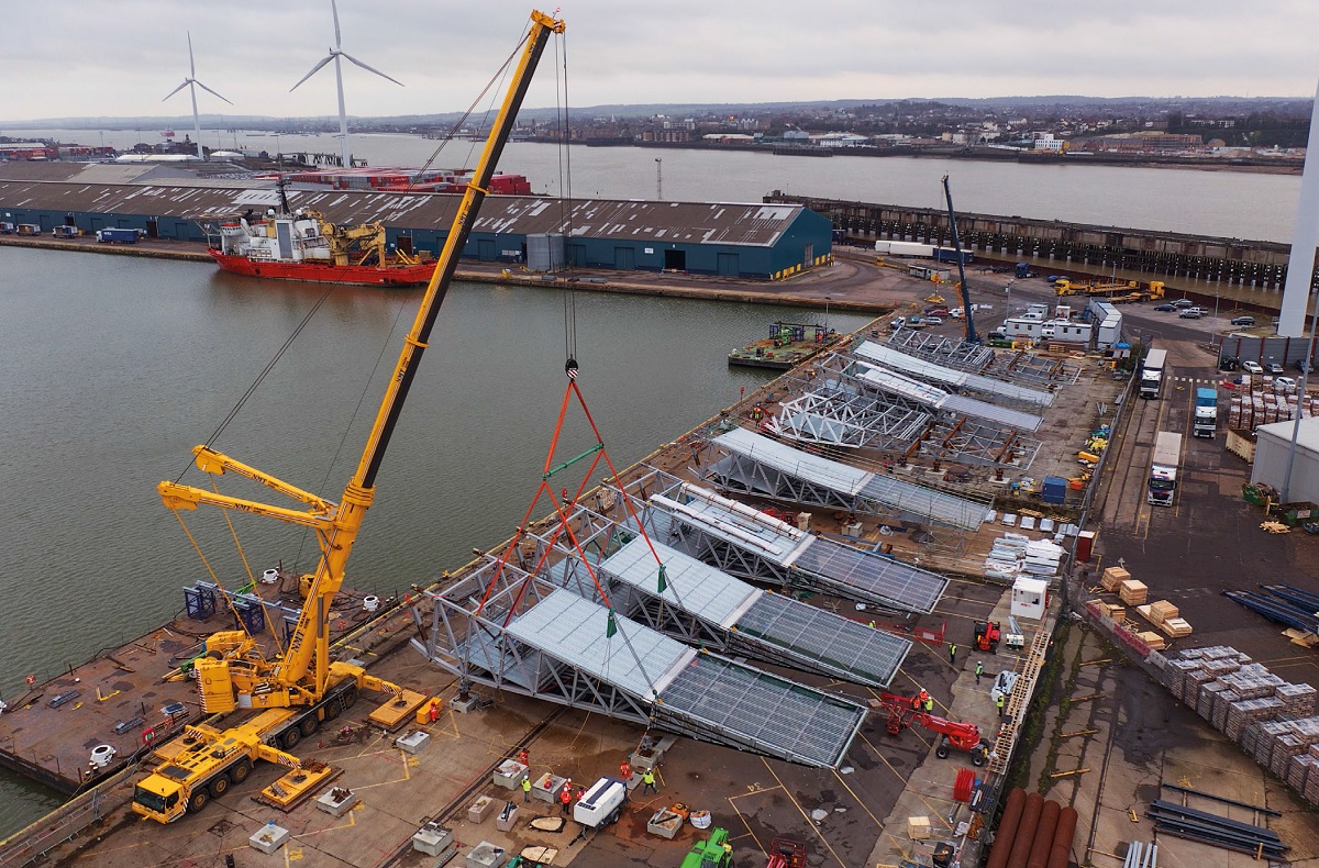 Due to onsite constraints, roof trusses are assembled at Tilbury Docks before being transported to site by barge