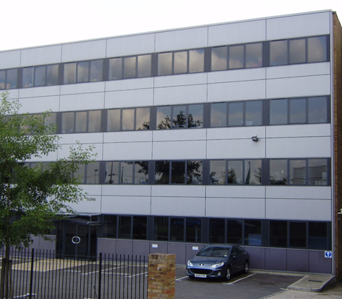 Use of large metallic panels in over-cladding of an existing office building.