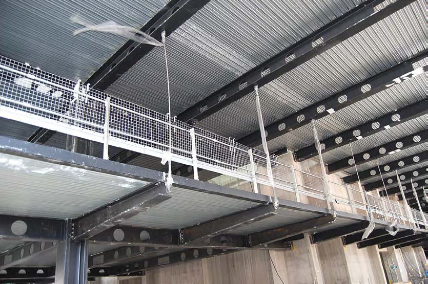 A cantilevering walkway overlooks the entrance and is suspended via hangers