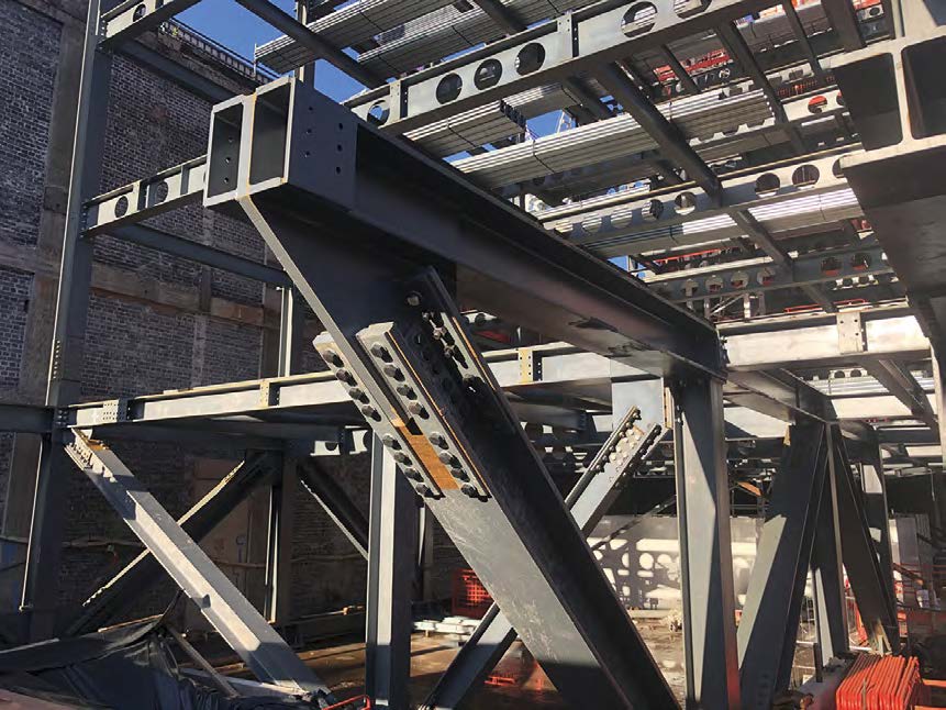 Two parallel trusses span a subterranean canal