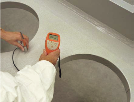 Off-site applied thin film intumescent coating being checked