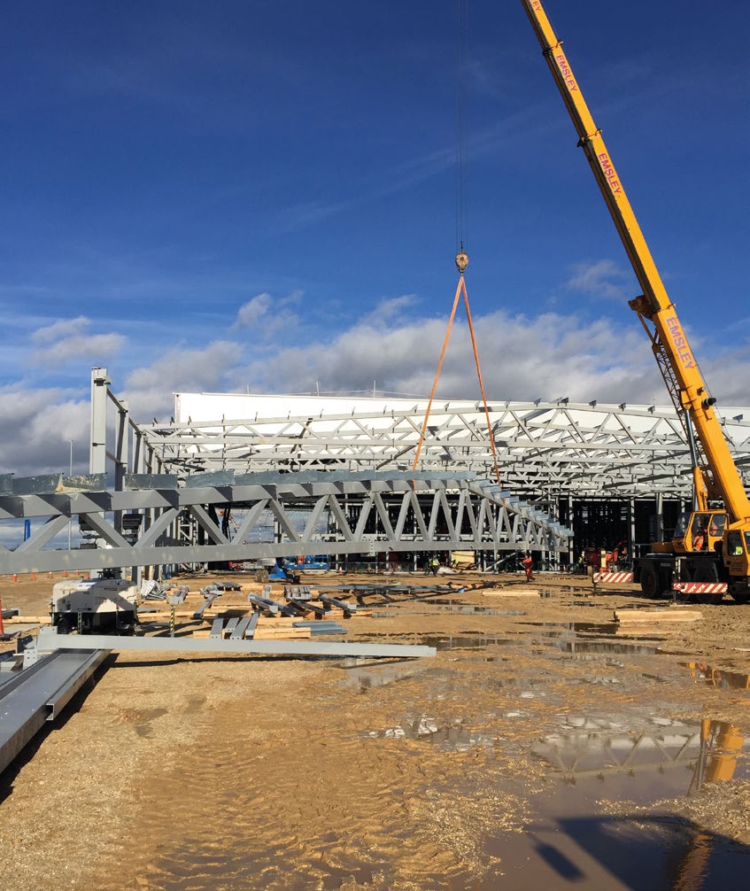 One of the large roof trusses is lifted into place