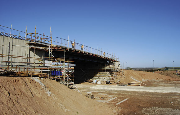 The Markham Moor bridge is being constructed on a busy roundabout with heavy traffic circulating around it continuously