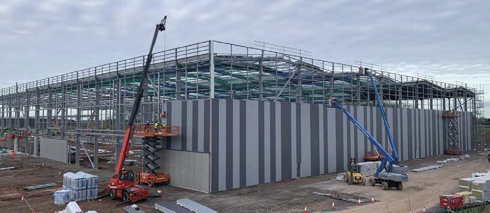 The cladding installers follow-on close behind the steel erection team