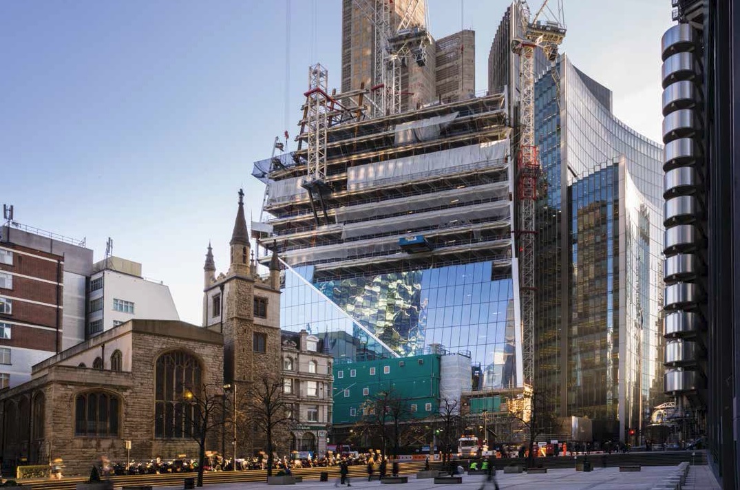 The glass cladding installation progresses behind the steel erection