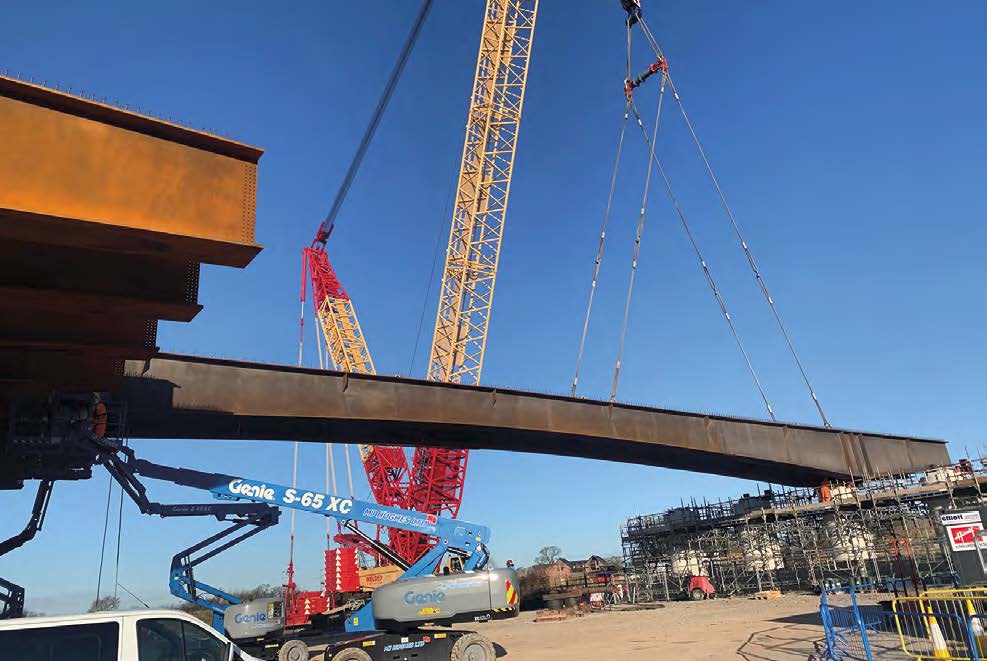 One of the main bridge girders of the Lea Viaduct is lifted into place