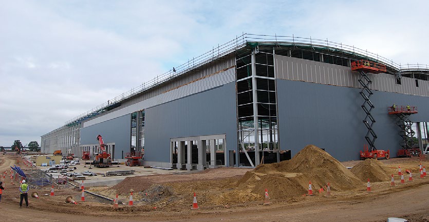 Cladding installation follows on behind the steel erection programme