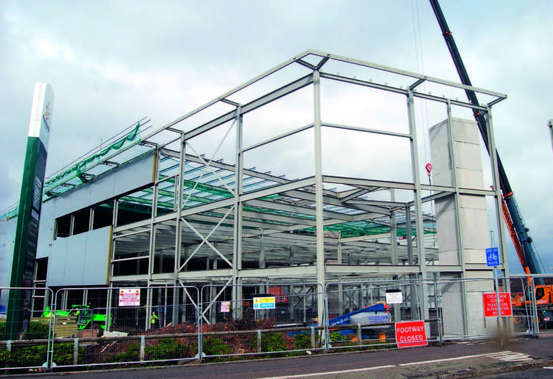 Mobile cranes help to erect the new build