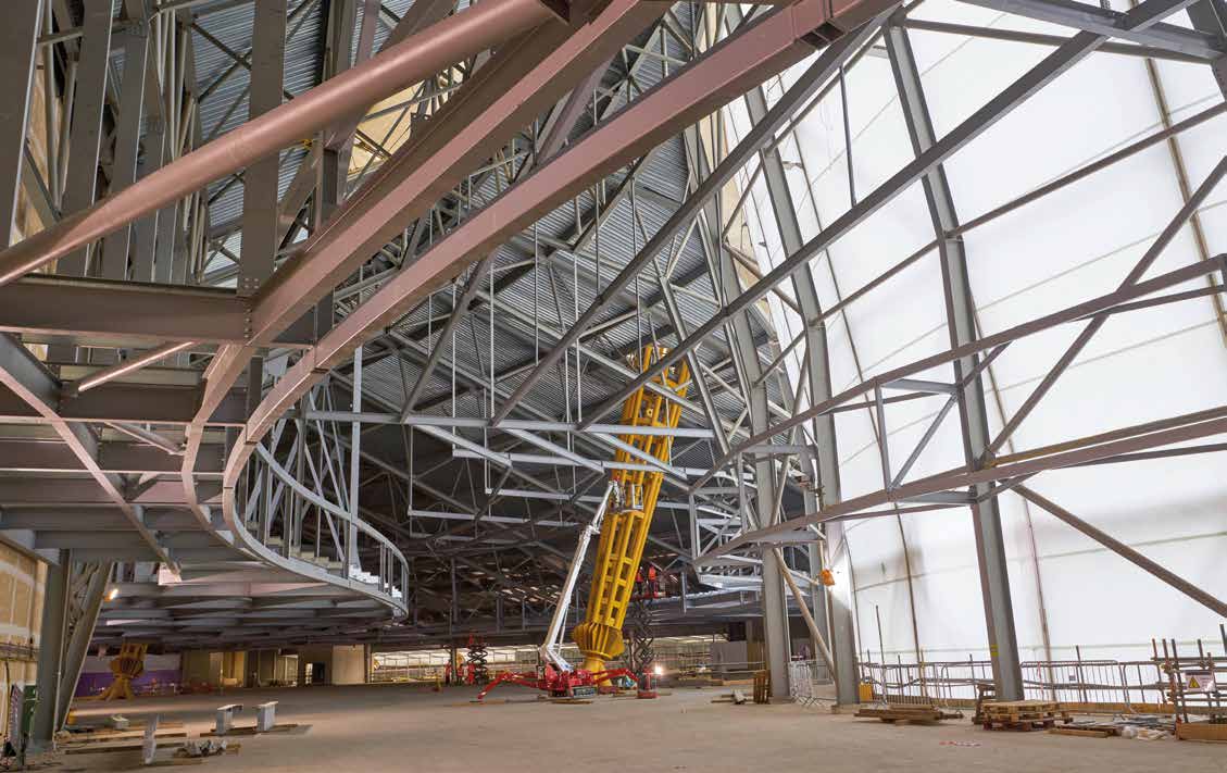 New steel connects to the existing trusses to form plant areas