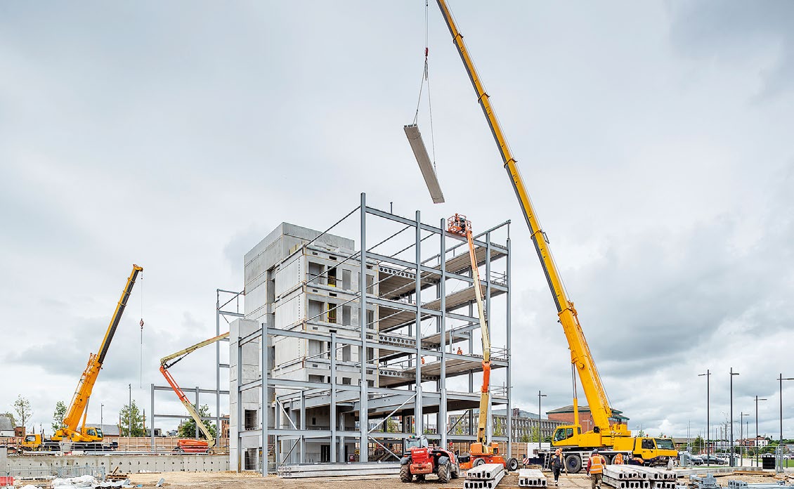 Precast flooring units are installed along with the main steel frame