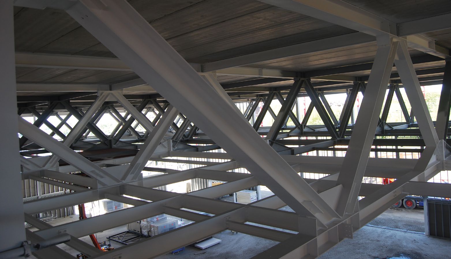 Trusses span the sports hall and support the football pitch above