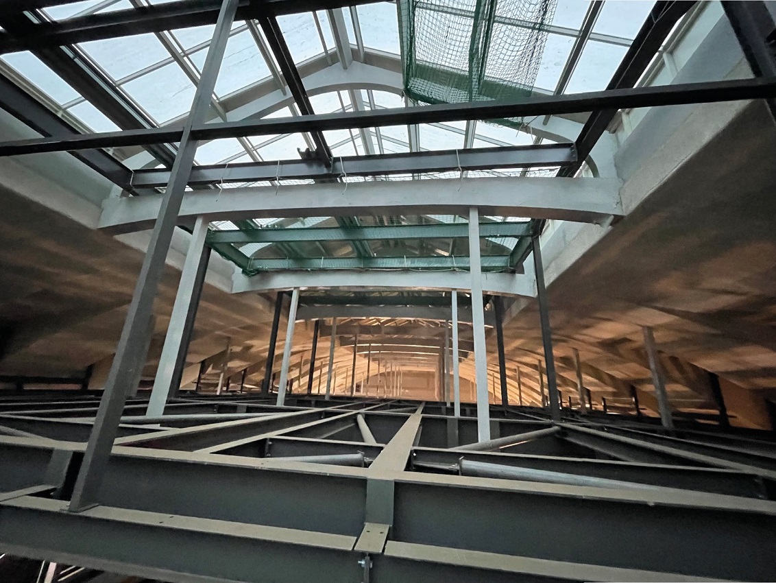New steelwork weaves its way through the existing listed concrete roof structure