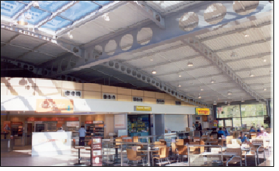 Structurally efficient cellular steel beams used to create flexible, column-free space at this motorway service station