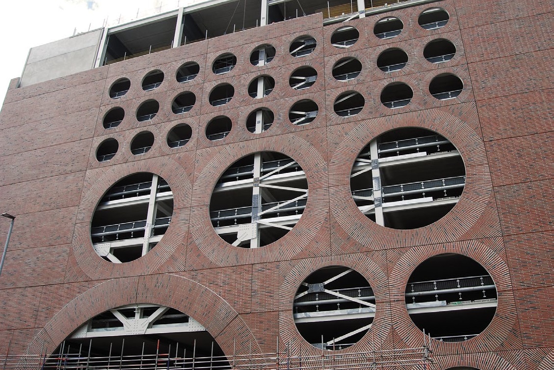 The cladding has holes allowing the steel frame to be visible