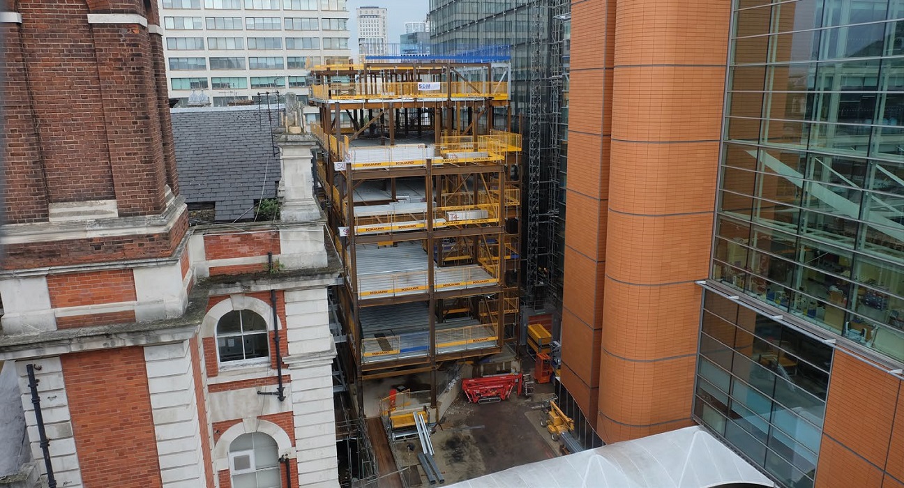 Squeezed in between two existing buildings, the site only has one access route, which dictated how the steel frame was erected