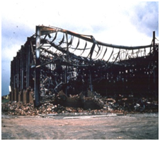 The side of a building which must not collapse in a fire will remain stable if protected and designed for base fixity