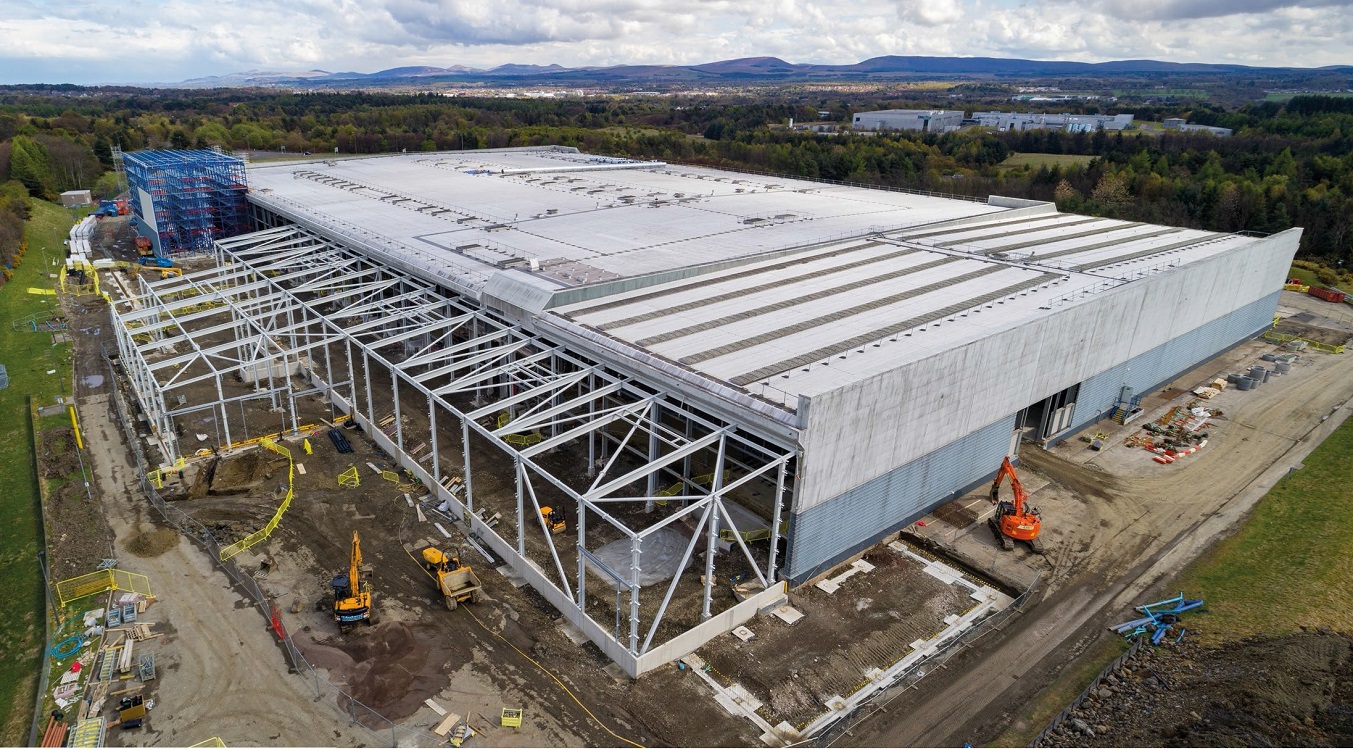 The largest extension runs along the existing building's northern elevation, adjacent to a new automated warehouse