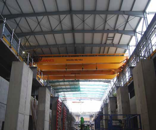 Large crane beams span the hall