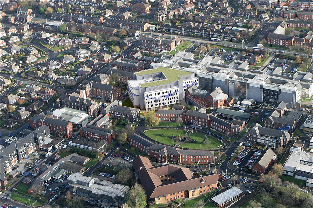 Impression of the completed extension (with green roof) sitting next to the existing hospital