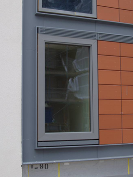Mixed use of metallic and tiled cladding in a residential building