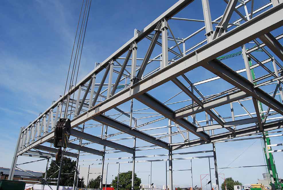 One of the initial long-span trusses is erected for the construction of the RRF building