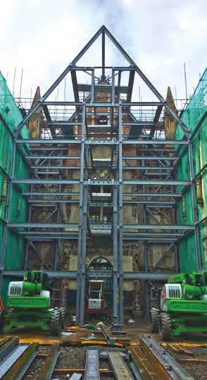 The steel frame goes up in the confined space of the chapel interior