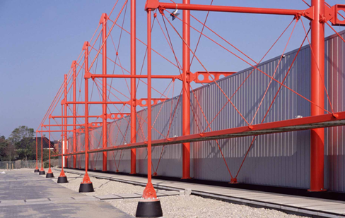 Cable stayed roof beams of a storage facility