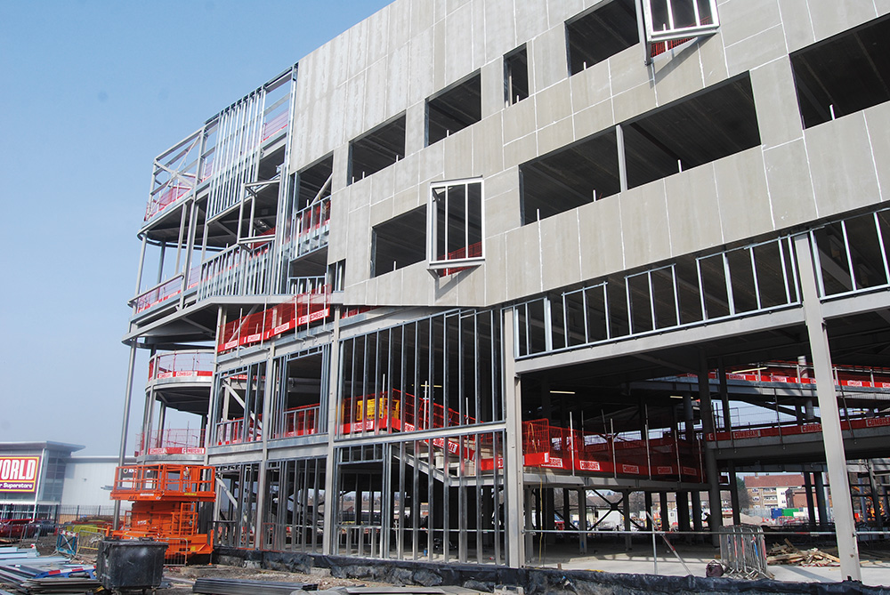 The structure’s grid alters to accommodate a ground floor drama space