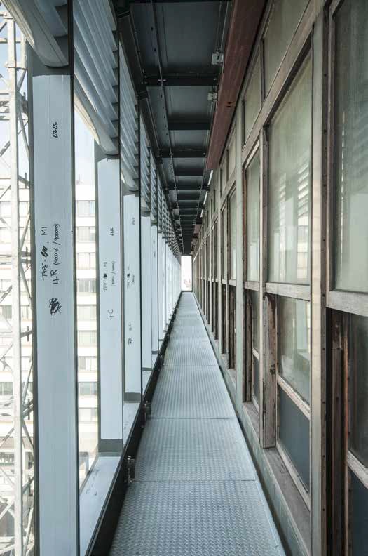 Maintenance balconies are positioned within the new façade