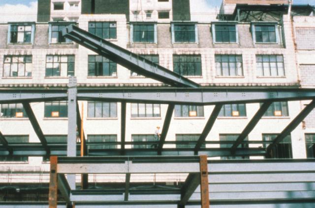 Tapered beams with facility for service integration next to the columns