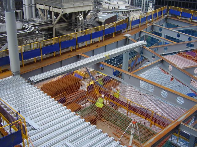 Installation of metal decking showing nets and edge protection