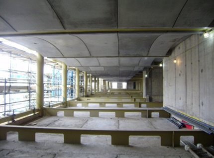 Precast concrete slabs supported by deep steel beams in which services are placed on the floor slab&lt;br&gt;(Woolwhich Town Hall)