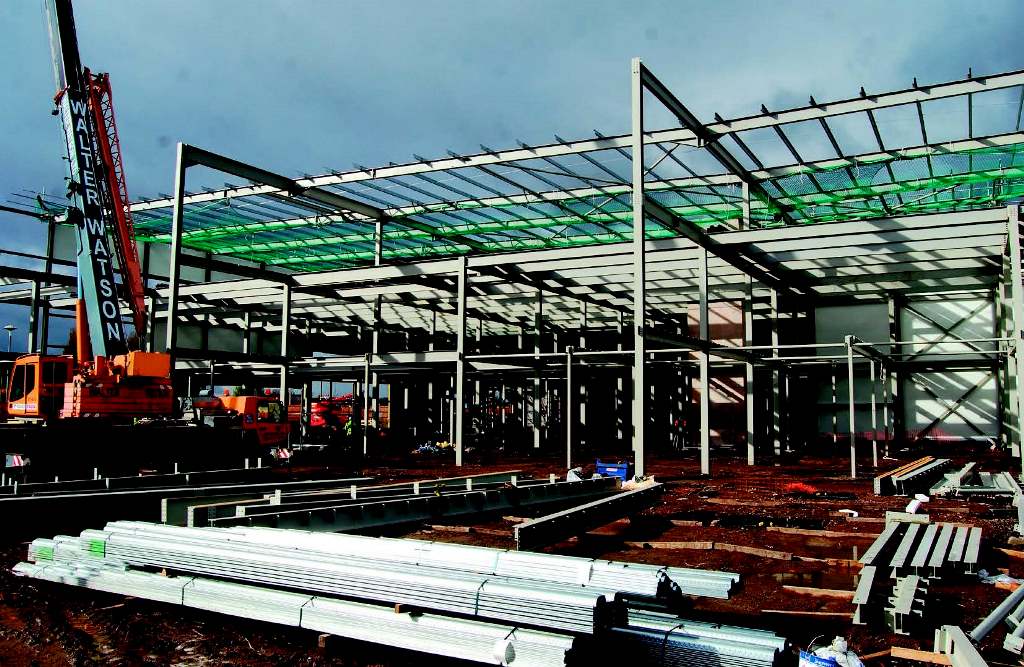 The new frame sits adjacent to the existing building