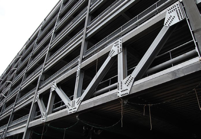 Large trusses form the access and exit points on the ground floor
