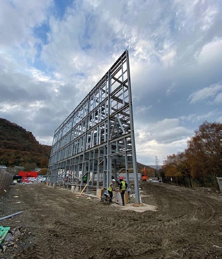 One end of the building has an angular feature tip