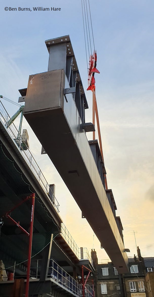 A fabricated girder is lifted into place