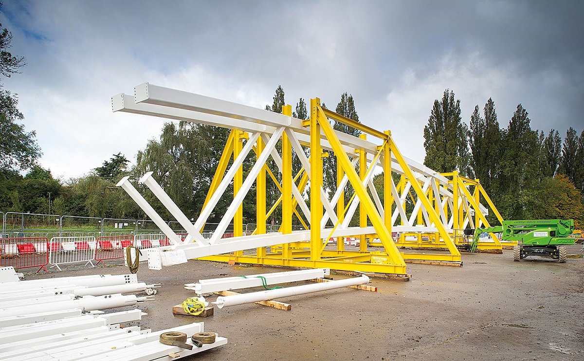 Truss sections are assembled into halves before being erected